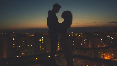 Night time on a rooftop in scene from a multicultural romance novel