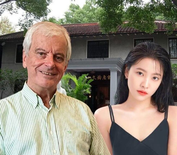 Robert Barclay author and Asian woman in front of house