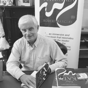 Man signing a book at a bookshop