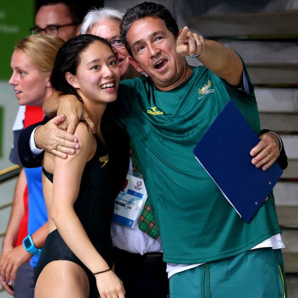 Female Asian diver with man celebrating