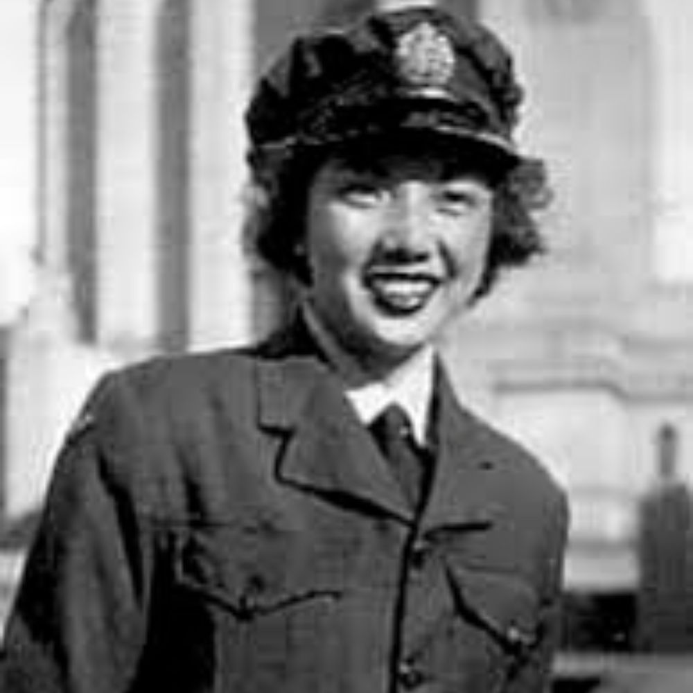 Asian woman in military uniform, smiling